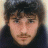 A 48x48 pixel buddy icon split into two sections: a left-side portrait of a person with dark hair and a right-side green background with bright green text reading "Original Icons .com".