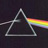 A pixelated triangular prism emits a rainbow spectrum against a dark background, with the prism rendered in grayscale tones.