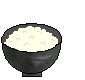Pixelated animation of a black bowl with white rice being filled by yellow scrambled eggs from a frying pan.