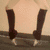 A four- shows a person's legs in dark knee-high socks and light shoes against a beige wall, with the right leg moving from side to side
