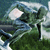 Pixelated static image of a helicopter with a light-colored rotor blade, dark body, and green foliage background under a blue sky.