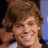 A pixelated image of a smiling person with brown hair on the left, next to green background text reading "I love Ryan Sheckler" in dark brown letters.