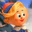 Pixelated cartoon character with blonde hair, red lips, and a white top against blue background.