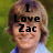 Pixelated image of a person with light brown hair wearing a light blue shirt, overlaid with black text reading "I Love Zac" against a green background.