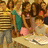 Pixelated group scene with people around a table, overlaid with pink text reading "My friends! They Rock Be Jealous" on black background.