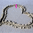 Two heart-shaped outlines made of small, light-colored beads on a gray background with pink text reading "I" and "Love" in the top section.