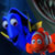 Pixelated static image of two cartoon fish characters from a popular animated film, one blue and one orange, positioned side-by-side against a dark background with blurred greenish elements.