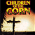 Pixelated static image of a burning book with yellow text reading "CHILDREN OF THE CORN" above it, set against a dark background.