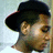 Pixelated static image of a person wearing a dark wide-brimmed hat, light skin tone, and brown hair visible beneath the brim.