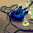 Animated sequence showing a blue electric guitar on a brown surface with yellow accents, transitioning to musical notes and a glowing golden note.