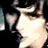 A static image with a blue background, featuring a pixelated close-up of a person's face on the left and white text reading "Personally stalked by Elaina" on the right.