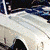 White car with blue racing stripes viewed from multiple angles in a pixelated animation.
