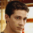 Pixelated image of a person with short dark hair and light skin, next to blue pixelated text on white background.