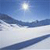 Pixelated landscape with blue sky, bright sun, and layered terrain in white and dark blue tones.