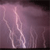 A static image of a lightning bolt against a dark purple background with pixelated edges.