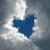 A blue heart shape appears in a cloudy sky, followed by a horse with colorful decorations and a black-and-white dog silhouette.