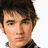 Pixelated image of a person with dark hair against a white background, paired with red text on black and gray sections.