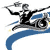 Pixelated figure in black suit rides a blue and gray vehicle with visible wheels, arms extended, holding a gray object above head.