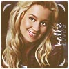 A static image of a smiling woman with long blonde hair, wearing a dark top, with partial text reading 'KELLY' on the right side.