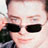 Pixelated static image of a person wearing dark sunglasses with visible facial features and partial clothing, rendered in low-resolution 48x48 pixels.