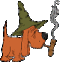 Animated orange cartoon dog wearing green witch hat, holding smoking pipe with smoke rising from it against gray background.