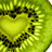 A static image of a sliced kiwi fruit with a heart-shaped center, displayed in three overlapping sections on a white background.