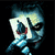 Pixelated image of a stylized face with blue and white tones, dark eye sockets, and a red mark on the cheek against a black background.