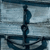 A pixelated anchor icon with a dark blue metal shaft and chain, set against a light blue and gray gradient background with horizontal lines.
