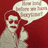Pixelated image of a person with red hair and light clothing against a solid red background, holding up one finger while speaking in a speech bubble.