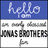 Pixelated image split into two vertical sections: left section has blue top with 'hello' text and white bottom with 'JONAS BROTHERS' text; right section has solid blue background with pink 'hello im an overly obsessed Jbros Fan' text.