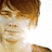 Pixelated close-up of a person's face with brown hair, light skin tone, and closed eyes against white background.