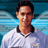 Pixelated static image of a person in a white sports jersey with dark collar against blue background, likely representing a soccer player.