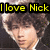 Pixelated image of a person with dark curly hair and light skin, overlaid by bold yellow text reading "I love Nick" on black rectangular backgrounds.
