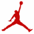 Red silhouette of a basketball player in mid-air jump shot pose with one arm extended upward holding a ball, set against white background.