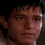 Pixelated close-up of a person's face with brown hair, showing two side-by-side views where the right view has slightly brighter lighting on the left cheek.