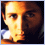 A pixelated face with warm lighting transitions from a dark background to a gradient sky, featuring a small heart symbol in the corner.