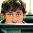 Pixelated image of a person with brown hair and blue eyes, partially visible behind a dark horizontal bar on light blue background.
