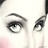Close-up of a stylized eye with thick black eyeliner and curved eyebrow on light skin, rendered in pixelated grayscale with subtle pink blush.