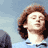 Pixelated static image of a person with brown hair against a light blue background, showing partial facial features and upper body in low-resolution 48x48 format.