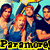 Group of people in blue and dark clothing with a woman making peace sign, text "Paramore" below.