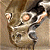A pixelated silver robot head with glowing orange eyes and a dark mouth area, positioned next to green text reading "Original Icons .com" on a solid background.