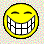 Static pixel art of a yellow smiley face with exaggerated teeth against a pastel checkered background.