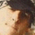 Pixelated close-up of a person's face with dark hair and light skin, showing partial facial features against a light background.