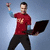 A person in a red shirt and black pants holds a laptop while raising one arm, with blue text partially visible at the bottom.