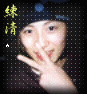 A person wearing a dark cap with a blue circular detail, making a peace sign with their right hand against a black dotted background with yellow Chinese characters and a white star.