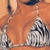 Static 50x50 pixel icon showing a partial view of a person in swimwear against an orange background with two white-and-gray abstract shapes.