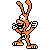 Pixelated orange cartoon mascot with long ears and checkered mouth, wearing white-and-black sports uniform with number 5, in two side-by-side animation frames showing different poses against gray background.