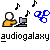 Pixelated icon shows a yellow-shirted figure with white head near a gray computer, black musical notes floating above, blue scissors on right, and 'audiogalaxy' text below on gray background.