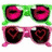 Green and pink sunglasses with heart-shaped lenses, zebra stripes, Hello Kitty faces, and high-heeled shoes on a person's feet.