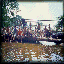 Six distinct scenes displayed in a : a crowd near water, two figures in red, a person on a train, a group in white, and a group with bicycles